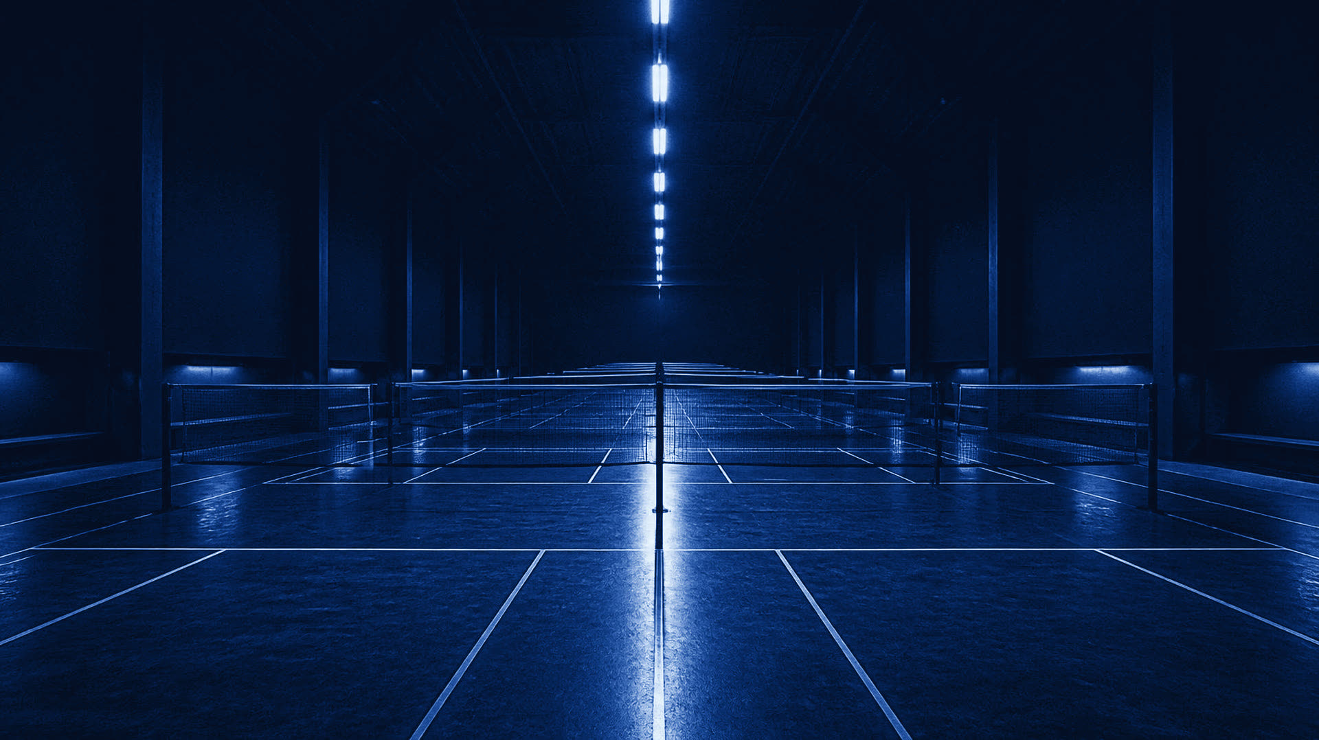 Badminton courts under the lights, ready to play